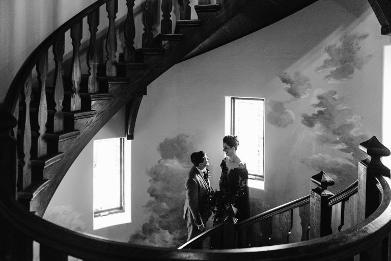 lisa+gavin embrace in the stairwell of Ladyhawk Castle during their wedding outside Asheville, NC